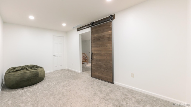 1755 Country View Dr, Okemos, MI 48864 - spare room featuring a barn door, carpet flooring, baseboards, and recessed lighting