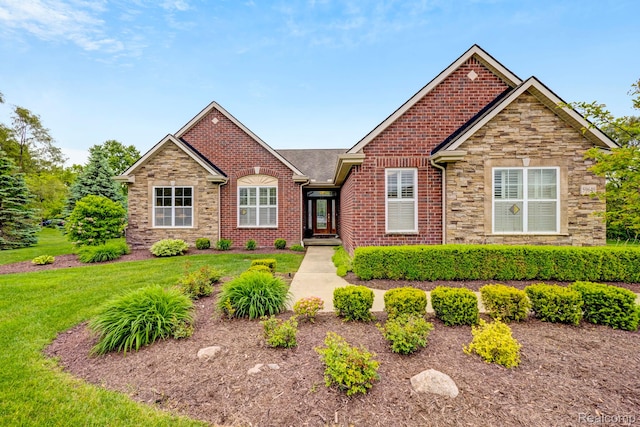 59649 Mallory Ln, South Lyon, MI 48178 - view of front facade featuring a front yard, stone siding, and brick siding
