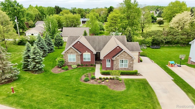 59649 Mallory Ln, South Lyon, MI 48178 - traditional-style home with stone siding, driveway, and a front yard