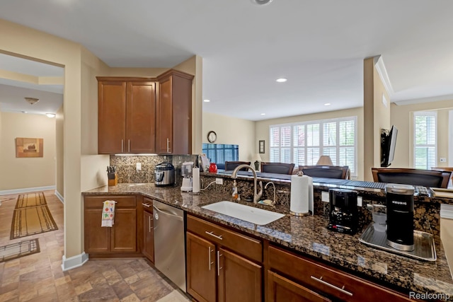59649 Mallory Ln, South Lyon, MI 48178 - kitchen featuring a sink, stainless steel dishwasher, dark stone counters, backsplash, and open floor plan