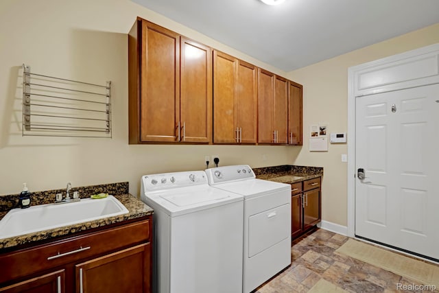 59649 Mallory Ln, South Lyon, MI 48178 - laundry room featuring cabinet space, washing machine and dryer, stone finish floors, and baseboards