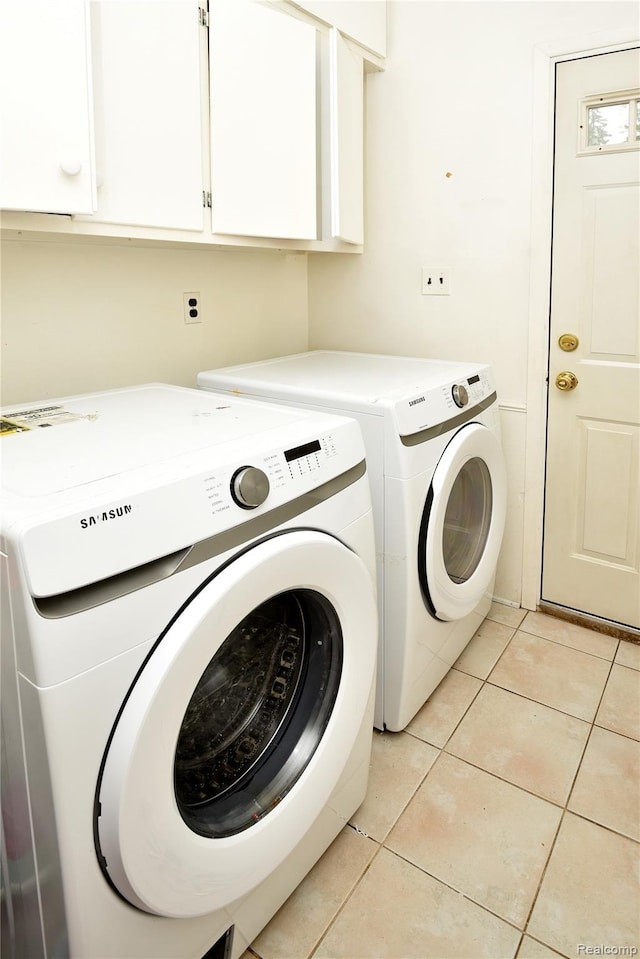 6835 Limerick Ln, Troy, MI 48098 - laundry room with independent washer and dryer, cabinet space, and light tile patterned floors