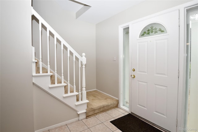 6835 Limerick Ln, Troy, MI 48098 - entryway featuring light tile patterned flooring, stairway, light colored carpet, and baseboards