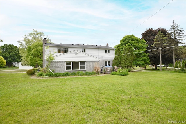 6835 Limerick Ln, Troy, MI 48098 - rear view of house featuring a chimney, a lawn, and brick siding