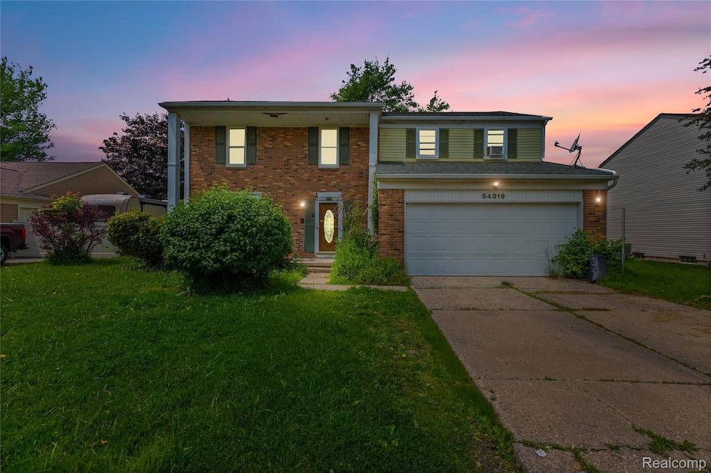 54319 Bradshaw Dr, New Baltimore, MI 48047 - view of front facade featuring driveway, brick siding, a front yard, and a garage