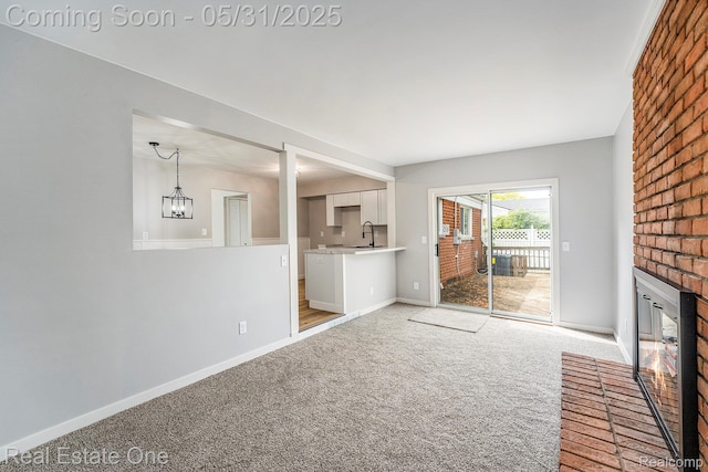 2809 Sparta Dr, Troy, MI 48083 - unfurnished living room featuring a brick fireplace, light carpet, a sink, and baseboards