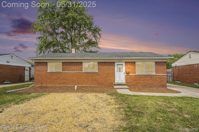 2809 Sparta Dr, Troy, MI 48083 - view of front facade with brick siding, a yard, a chimney, and a shingled roof