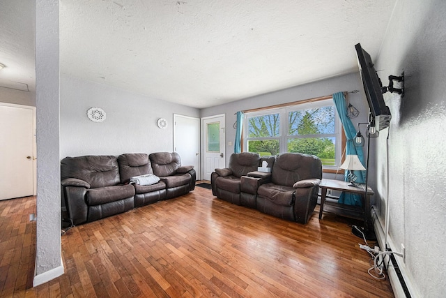 3225 Fishville Rd, Grass Lake, MI 49240 - living area with wood-type flooring, a textured ceiling, and a textured wall