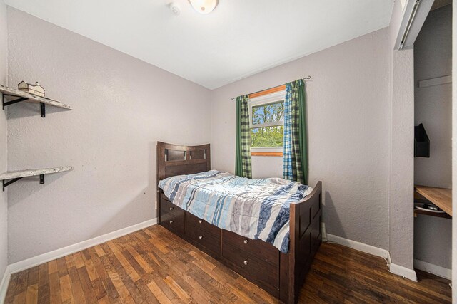 3225 Fishville Rd, Grass Lake, MI 49240 - bedroom with wood finished floors, vaulted ceiling, and baseboards