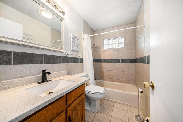 3225 Fishville Rd, Grass Lake, MI 49240 - full bath with shower / bath combo, vanity, toilet, tile patterned flooring, and a textured ceiling