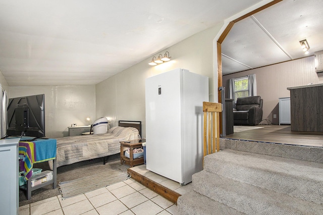 24923 Sandy Beach Dr, Edwardsburg, MI 49112 - bedroom with light tile patterned flooring and freestanding refrigerator
