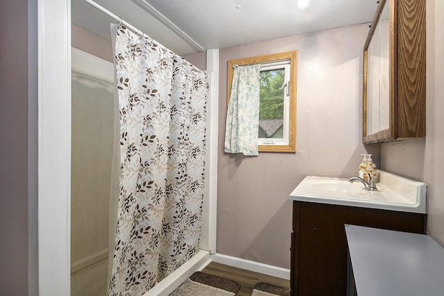 24923 Sandy Beach Dr, Edwardsburg, MI 49112 - full bath featuring vanity, wood finished floors, a shower stall, and baseboards