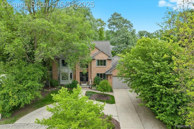 5182 Shady Creek Dr, Troy, MI 48085 - view of front of property featuring brick siding, concrete driveway, an attached garage, and a shingled roof