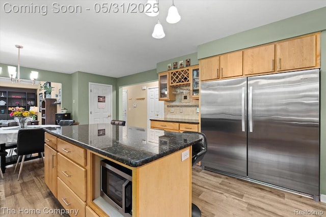 5182 Shady Creek Dr, Troy, MI 48085 - kitchen featuring stainless steel appliances, a chandelier, light wood-style flooring, and glass insert cabinets