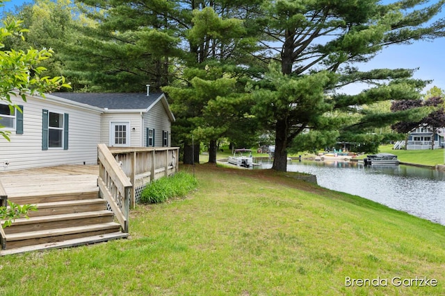 17055 Blackfoot Trl, Howard City, MI 49329 - view of grassy yard featuring a deck with water view