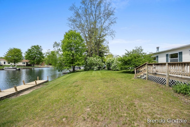 17055 Blackfoot Trl, Howard City, MI 49329 - view of green lawn with a deck with water view