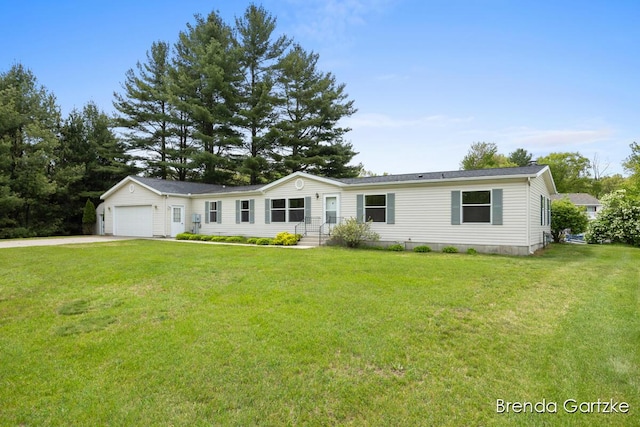 17055 Blackfoot Trl, Howard City, MI 49329 - manufactured / mobile home with concrete driveway, a garage, and a front yard