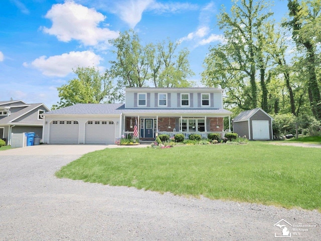 11963 Egan Hwy, Brooklyn, MI 49230 - traditional home featuring a storage shed, a porch, a garage, driveway, and a front lawn