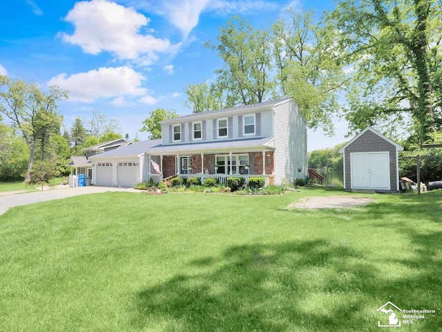 11963 Egan Hwy, Brooklyn, MI 49230 - view of front of property featuring covered porch, a storage unit, a garage, and a front lawn