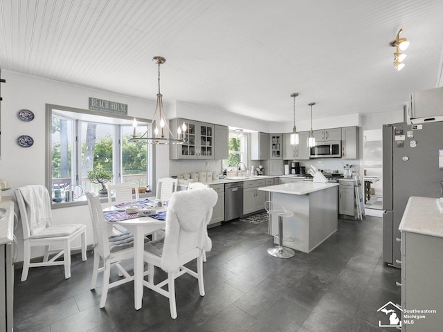 11963 Egan Hwy, Brooklyn, MI 49230 - kitchen with gray cabinetry, stainless steel appliances, glass insert cabinets, and light countertops