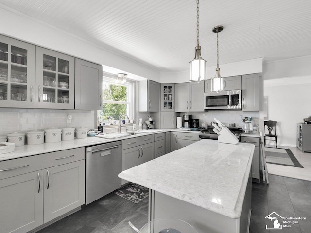 11963 Egan Hwy, Brooklyn, MI 49230 - kitchen featuring stainless steel appliances, gray cabinetry, backsplash, decorative light fixtures, and glass insert cabinets