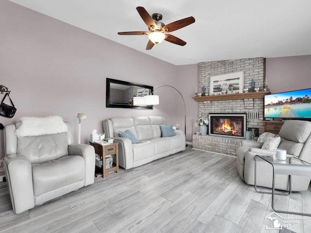 11963 Egan Hwy, Brooklyn, MI 49230 - living area with ceiling fan, light wood finished floors, and a brick fireplace