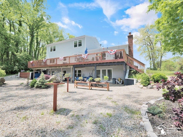 11963 Egan Hwy, Brooklyn, MI 49230 - rear view of house featuring a wooden deck, a chimney, and a patio