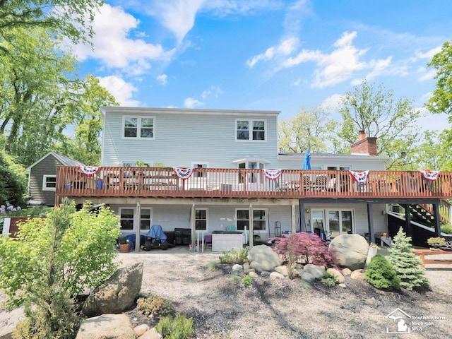 11963 Egan Hwy, Brooklyn, MI 49230 - back of property featuring a wooden deck, a chimney, and a patio