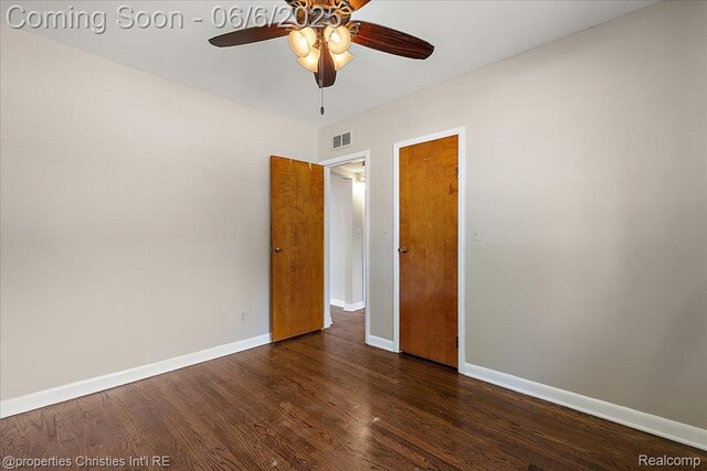 15501 Portis St, Northville, MI 48170 - unfurnished bedroom featuring dark wood-type flooring, baseboards, and a ceiling fan