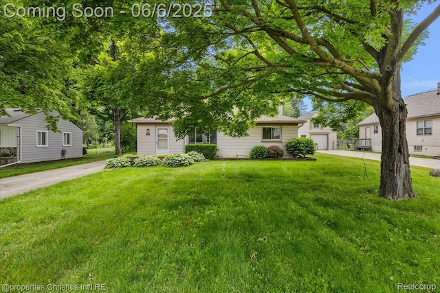 15501 Portis St, Northville, MI 48170 - obstructed view of property featuring a front lawn and a garage