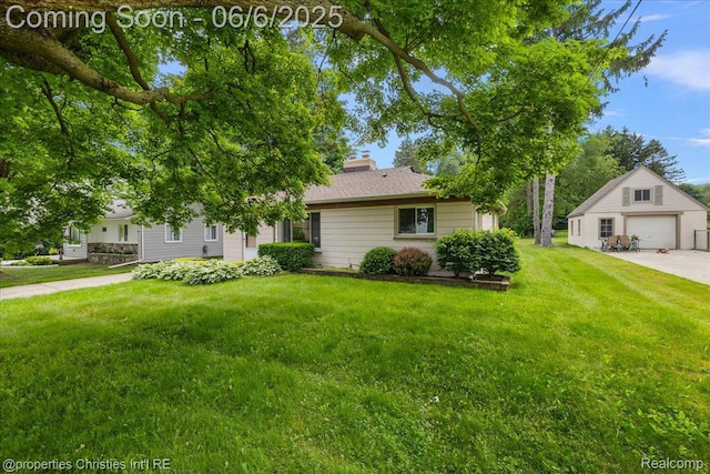 15501 Portis St, Northville, MI 48170 - view of front facade with an outbuilding, a front lawn, a chimney, and a garage