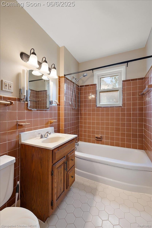 15501 Portis St, Northville, MI 48170 - full bathroom with tile patterned floors, toilet, shower / washtub combination, vanity, and tile walls