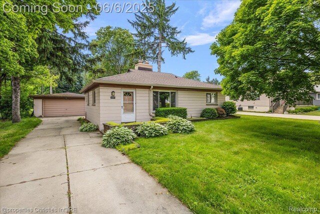 15501 Portis St, Northville, MI 48170 - view of front of home featuring an outbuilding, a front yard, a chimney, and a detached garage