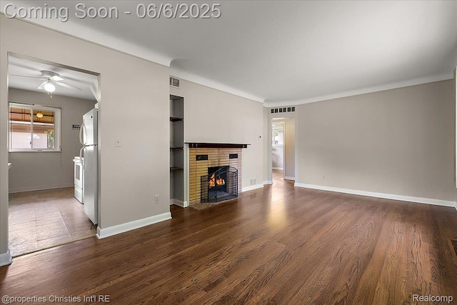 15501 Portis St, Northville, MI 48170 - unfurnished living room featuring a brick fireplace, wood finished floors, a ceiling fan, and baseboards
