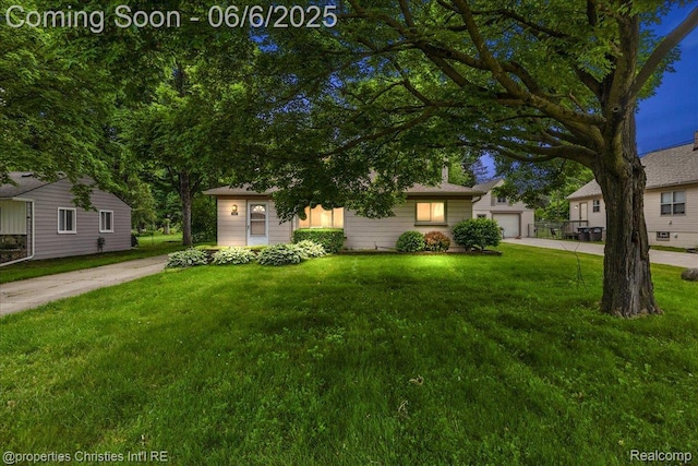 15501 Portis St, Northville, MI 48170 - obstructed view of property with a front yard, concrete driveway, and a garage