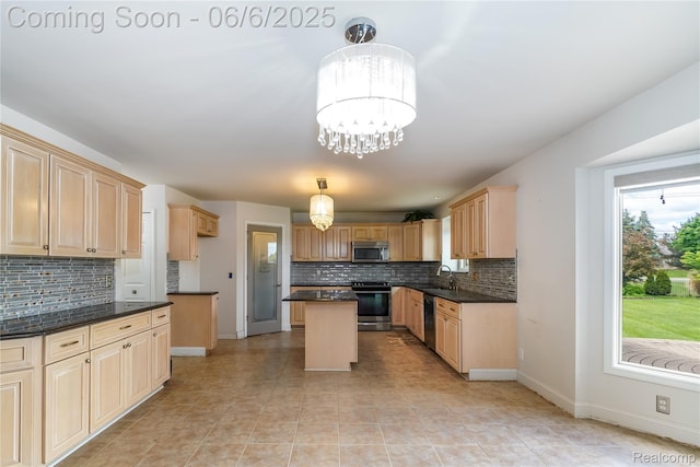42105 Dorchester Ct, Clinton Township, MI 48038 - kitchen featuring appliances with stainless steel finishes, a sink, tasteful backsplash, and a center island