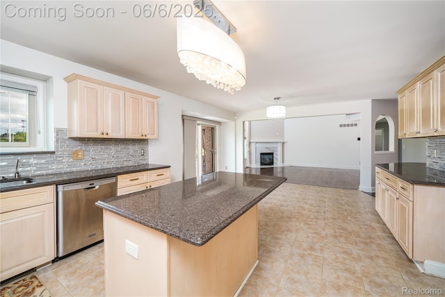 42105 Dorchester Ct, Clinton Township, MI 48038 - kitchen featuring dishwasher, decorative backsplash, a center island, open floor plan, and light brown cabinetry