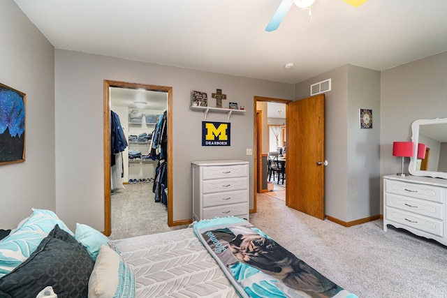 424 Gale Ct, Ithaca, MI 48847 - bedroom featuring a spacious closet, light colored carpet, a closet, a ceiling fan, and baseboards
