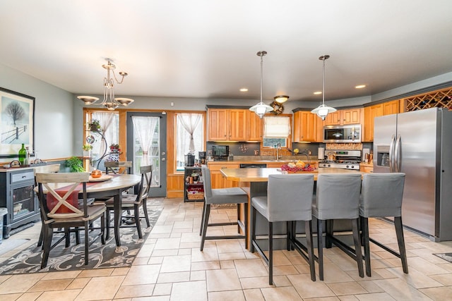 424 Gale Ct, Ithaca, MI 48847 - kitchen featuring stainless steel appliances, light countertops, recessed lighting, decorative light fixtures, and a center island