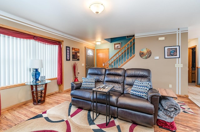 424 Gale Ct, Ithaca, MI 48847 - living room featuring wood finished floors, stairs, and baseboards