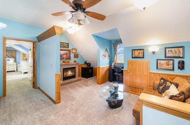 424 Gale Ct, Ithaca, MI 48847 - living area featuring lofted ceiling, carpet floors, wainscoting, ceiling fan, and a fireplace