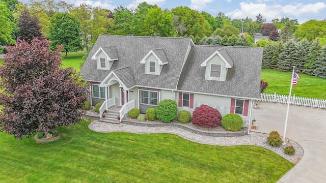 424 Gale Ct, Ithaca, MI 48847 - cape cod house featuring a shingled roof and concrete driveway