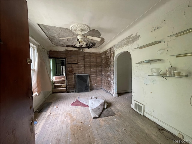 17184 Mackay St, Detroit, MI 48212 - unfurnished living room with arched walkways, ceiling fan, and wood-type flooring