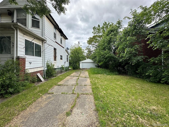 17184 Mackay St, Detroit, MI 48212 - view of green lawn featuring a garage and an outbuilding