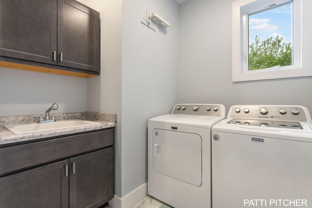 104 River Hills Dr, Holland, MI 49424 - laundry room with cabinet space, separate washer and dryer, light marble finish floors, and baseboards