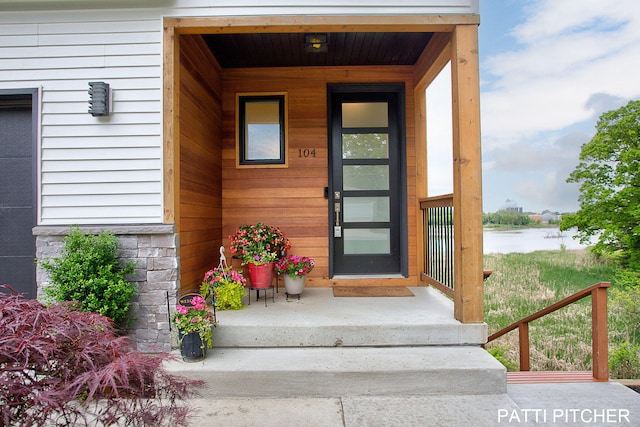104 River Hills Dr, Holland, MI 49424 - property entrance featuring a water view and a porch