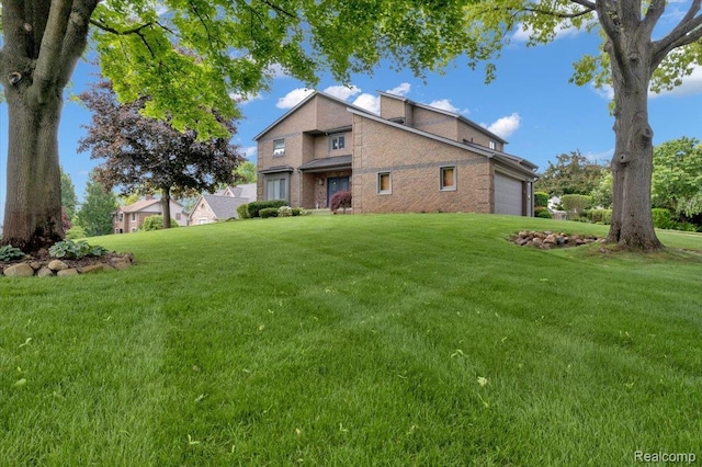 61381 Miriam Dr, Washington, MI 48094 - rear view of house with a garage, a yard, and brick siding