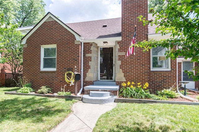 19988 Macarthur St, Redford, MI 48240 - view of front of home with brick siding, roof with shingles, and a front yard