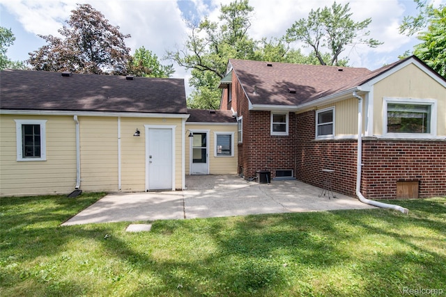 19988 Macarthur St, Redford, MI 48240 - back of property featuring a lawn, a patio, and roof with shingles