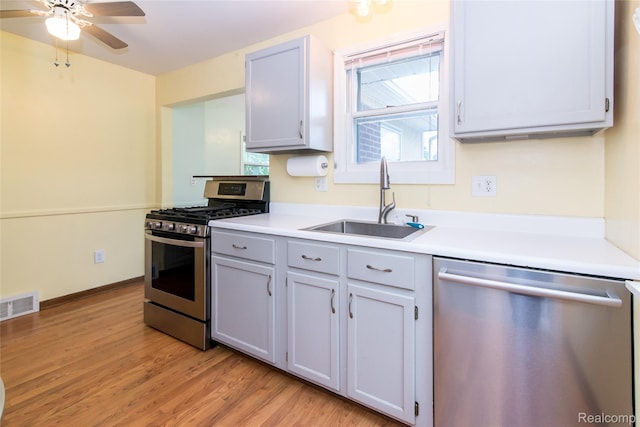 19988 Macarthur St, Redford, MI 48240 - kitchen featuring appliances with stainless steel finishes, light wood-type flooring, ceiling fan, and light countertops
